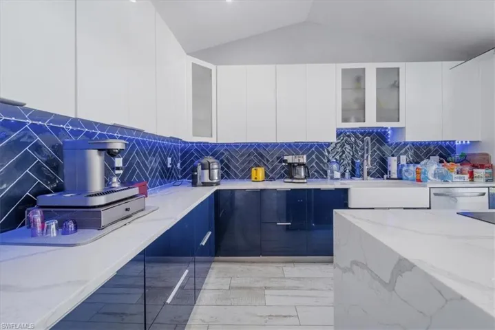 Kitchen featuring white cabinets, light wood-type flooring, island exhaust hood, black electric cooktop, and beverage cooler