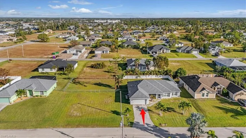 Ranch-style home featuring a front lawn and a garage