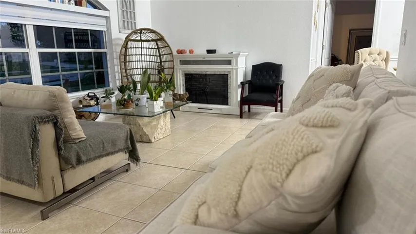 Tiled living room featuring a fireplace