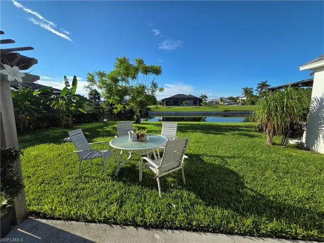 View of grassy yard with a water view