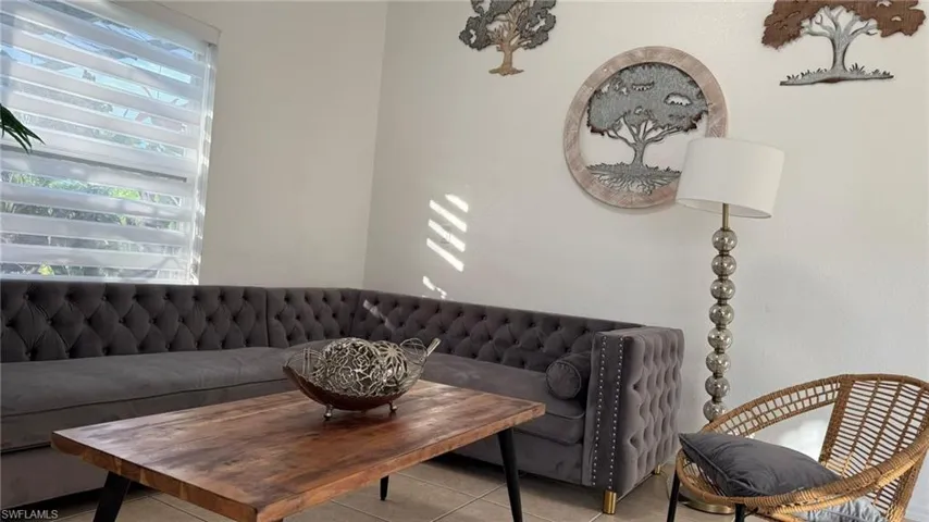 Living room with light tile patterned flooring