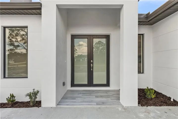 Entrance to property with french doors and stucco siding