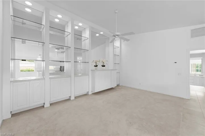 Spare room with recessed lighting, light colored carpet, and a ceiling fan