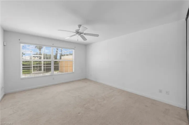 Unfurnished room with carpet flooring and a ceiling fan