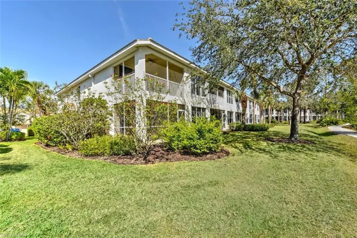 View of side of home with a lawn