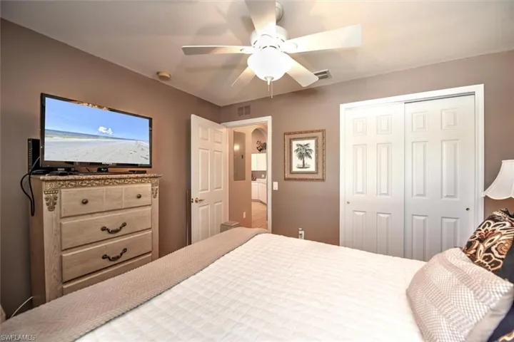 Bedroom featuring a closet, ceiling fan, and visible vents