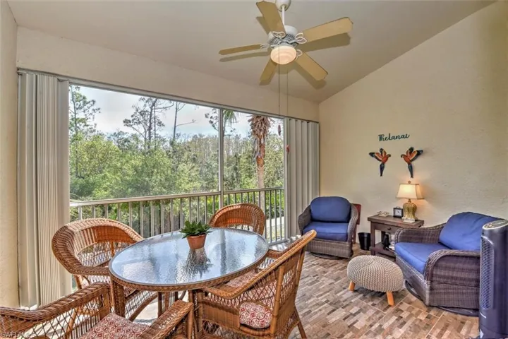 Sunroom with outdoor dining space and a ceiling fan