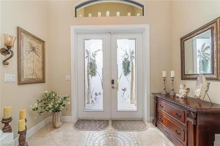 Doorway to outside with french doors and light tile patterned flooring