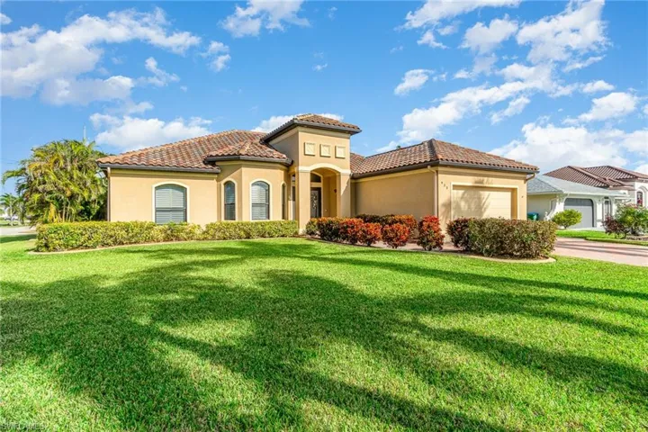 Mediterranean / spanish-style home featuring a front yard and a garage