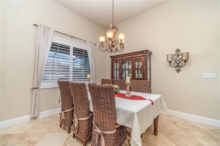 Dining room featuring a chandelier and lofted ceiling