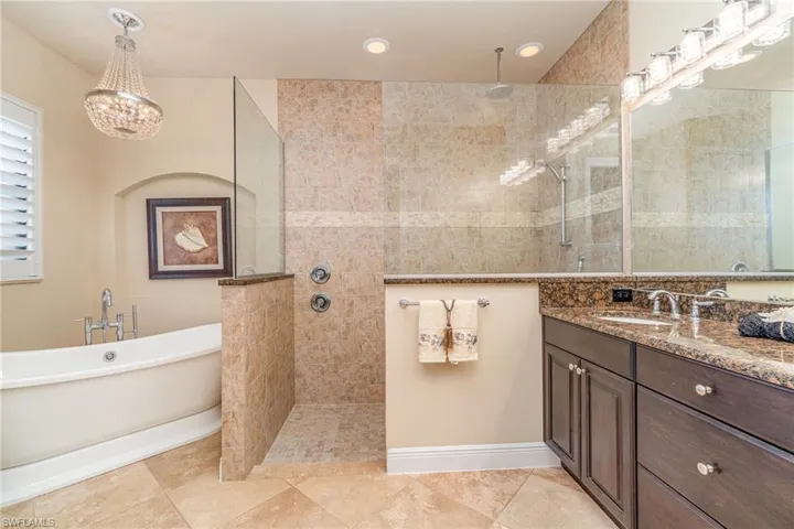 Bathroom with vanity and separate shower and tub