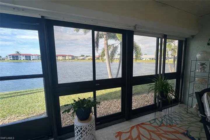 Sunroom featuring a water view