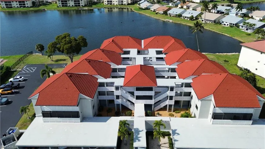 Aerial view of a nearby body of water and apartment complex / building