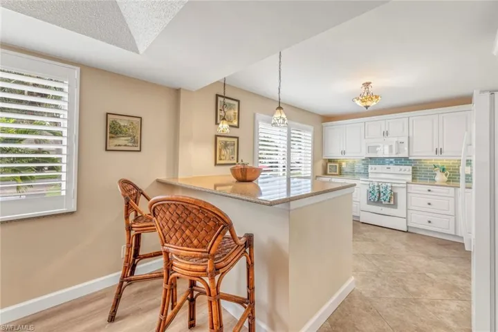 Breakfast or bar stools with counter to kitchen. Perfect area for serving buffet or cocktail hour!