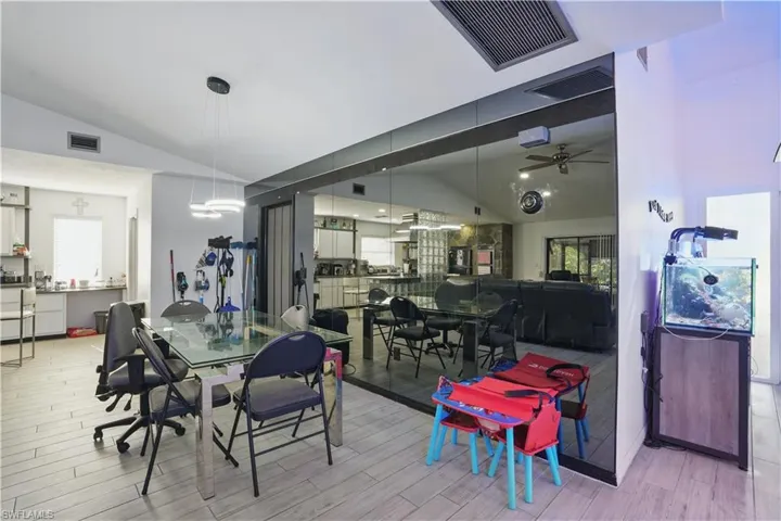 Dining area with vaulted ceiling, ceiling fan, and wood finished floors
