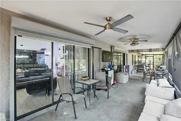 Sunroom / solarium featuring outdoor dining space, a ceiling fan, and an outdoor living space
