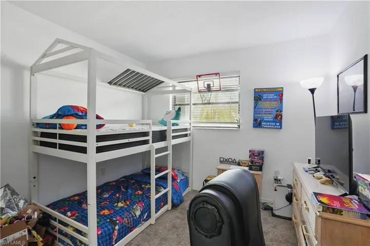 Bedroom with light colored carpet