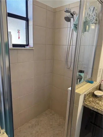 Full bath with a stall shower and vanity