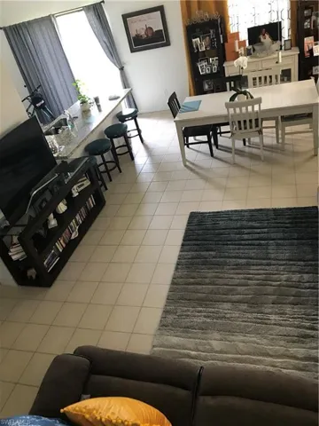 Living area with light tile patterned flooring