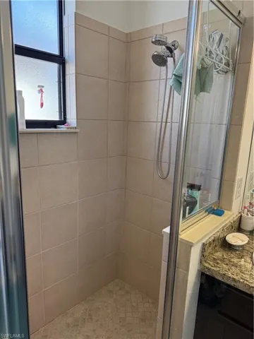Full bathroom featuring a shower stall