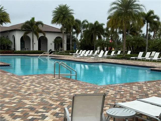 Community pool with a patio