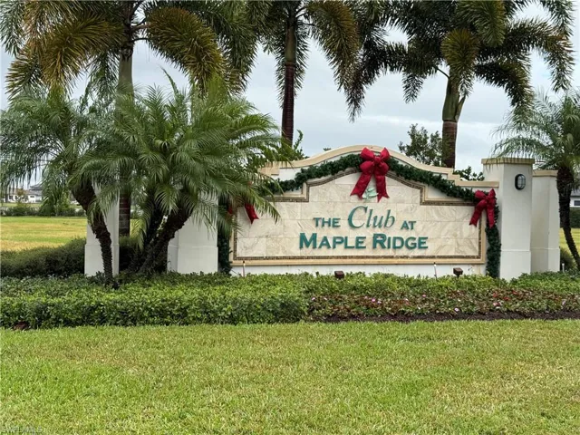 Community / neighborhood sign with a lawn