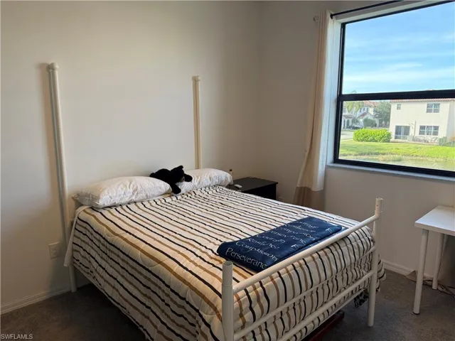 Bedroom with dark colored carpet