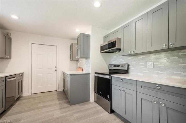 Check Out the Backsplash and Diamond Cabinet Knobs. The Door leads to the Garage