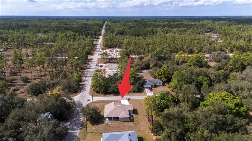 Aerial view of property's location featuring a heavily wooded area