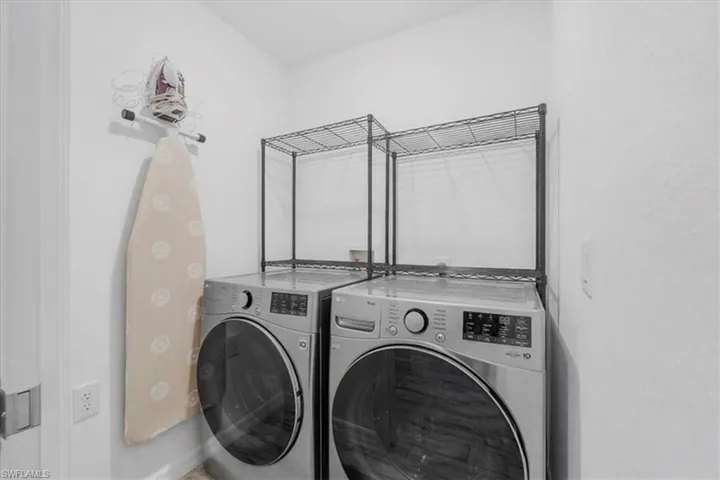 Laundry area featuring washer and dryer and baseboards