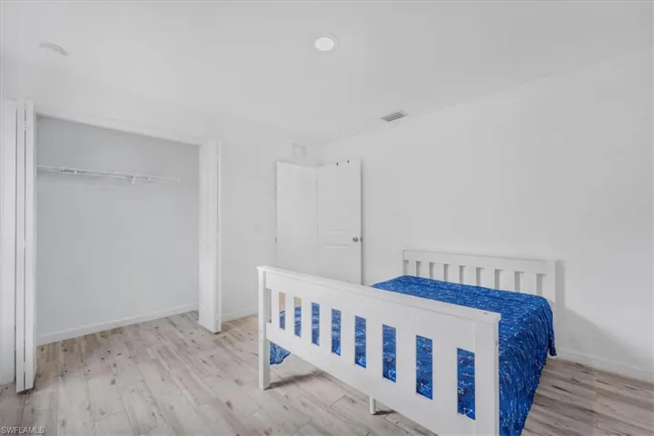 Bedroom featuring light wood-style floors and a closet