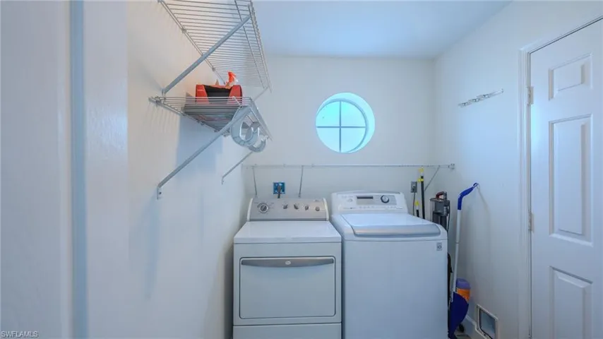 Laundry room with washing machine and clothes dryer