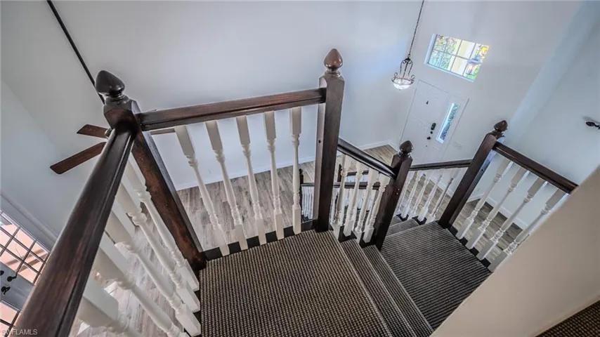Stairs featuring carpet floors and a high ceiling