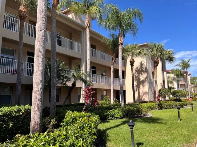 View of property with assigned carport