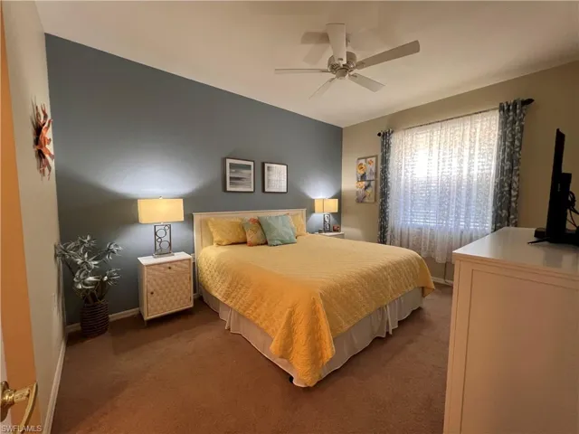 Primary Bedroom with carpet flooring and ceiling fan