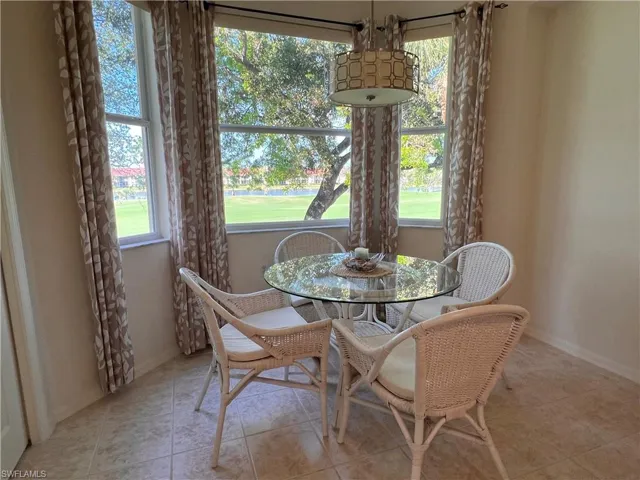 Tiled dining room with a healthy amount of sunlight