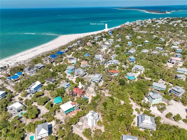 Drone / aerial view with a water view and a view of the beach