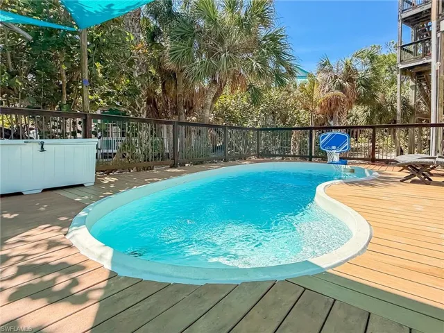 View of swimming pool with a deck and a fenced in pool