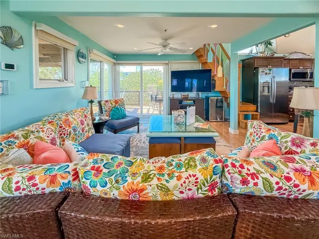 Living room with recessed lighting, ceiling fan, and light wood-style flooring
