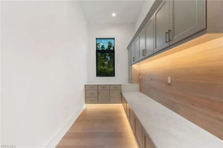 Mudroom with baseboards, recessed lighting, and light wood-style floors