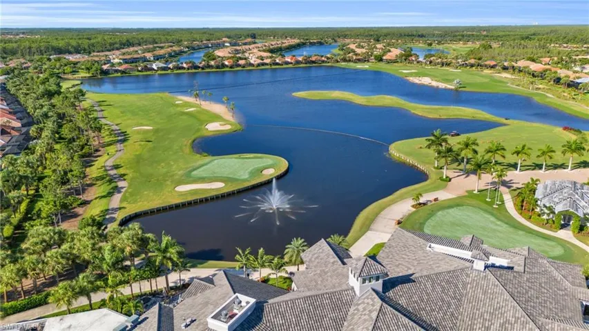 Birds eye view of property with a water view