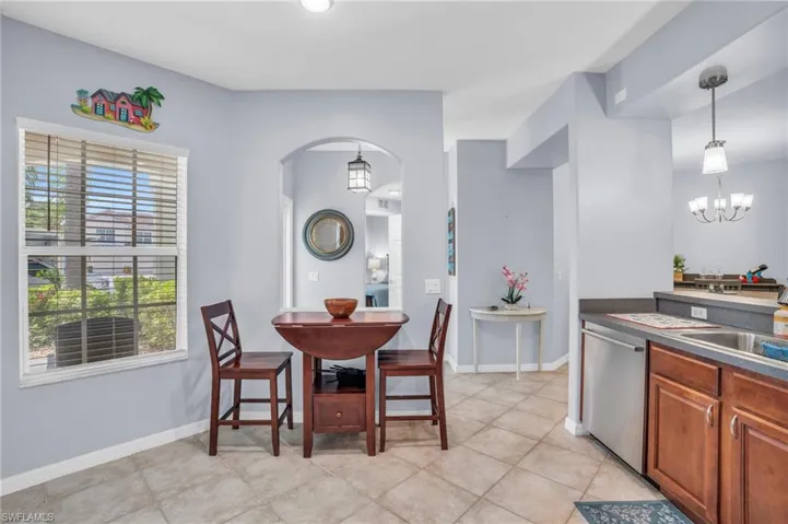 Tiled dining room with an inviting chandelier