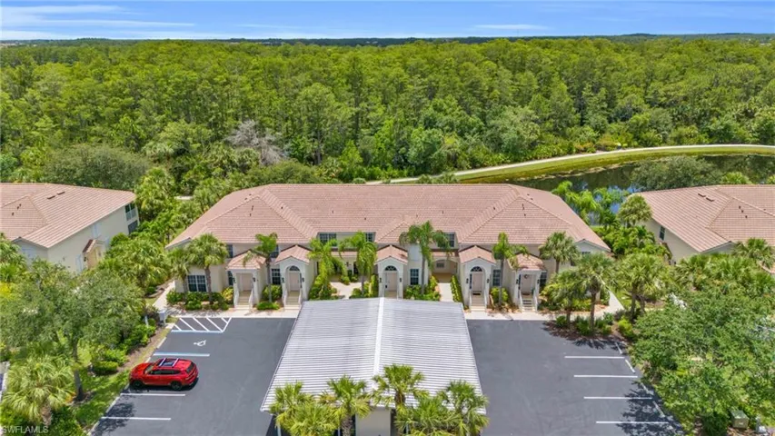 View of aerial view - covered assigned parking to the right and guest parking on the left