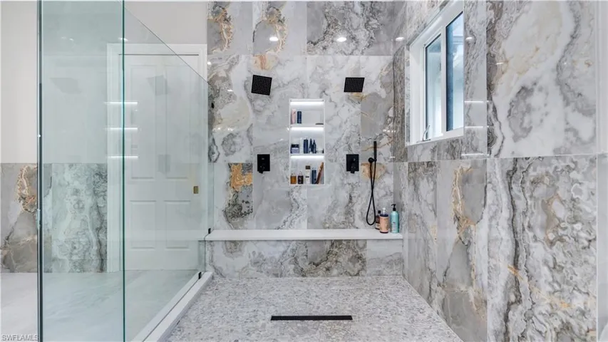 Bathroom featuring a marble finish shower