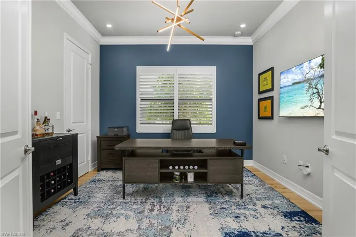 Office area featuring a chandelier, light wood-style floors, ornamental molding, and recessed lighting