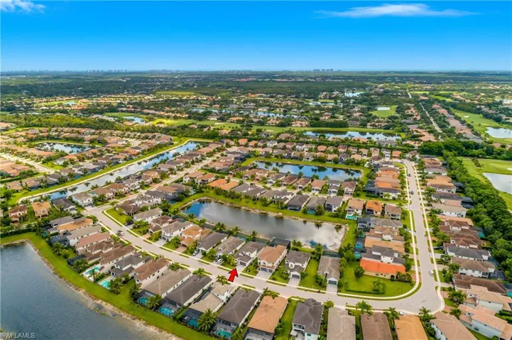 Aerial overview of property's location with a nearby body of water and nearby suburban area