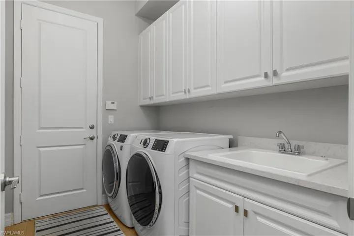 Washroom with separate washer and dryer and cabinet space