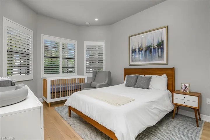 Bedroom with light wood-type flooring and recessed lighting