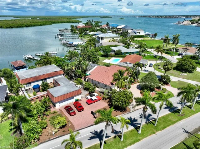 Birds eye view of property with a water view