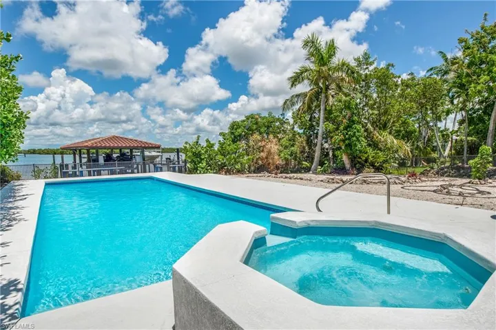 View of swimming pool featuring an in ground hot tub and a gazebo